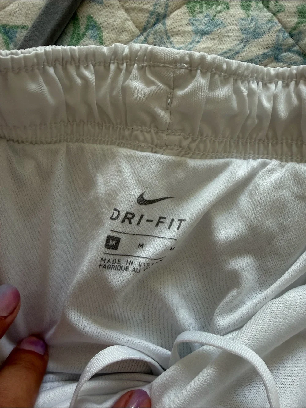 Nike Dri-Fit white running shorts with orange trim, size M